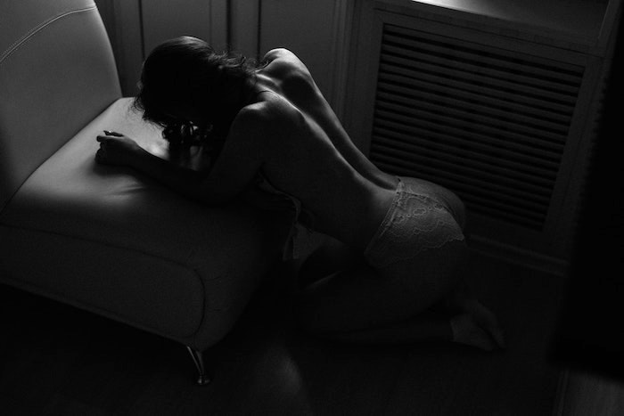 rules for submissives - topless woman kneeling on the floor resting elbows on chair